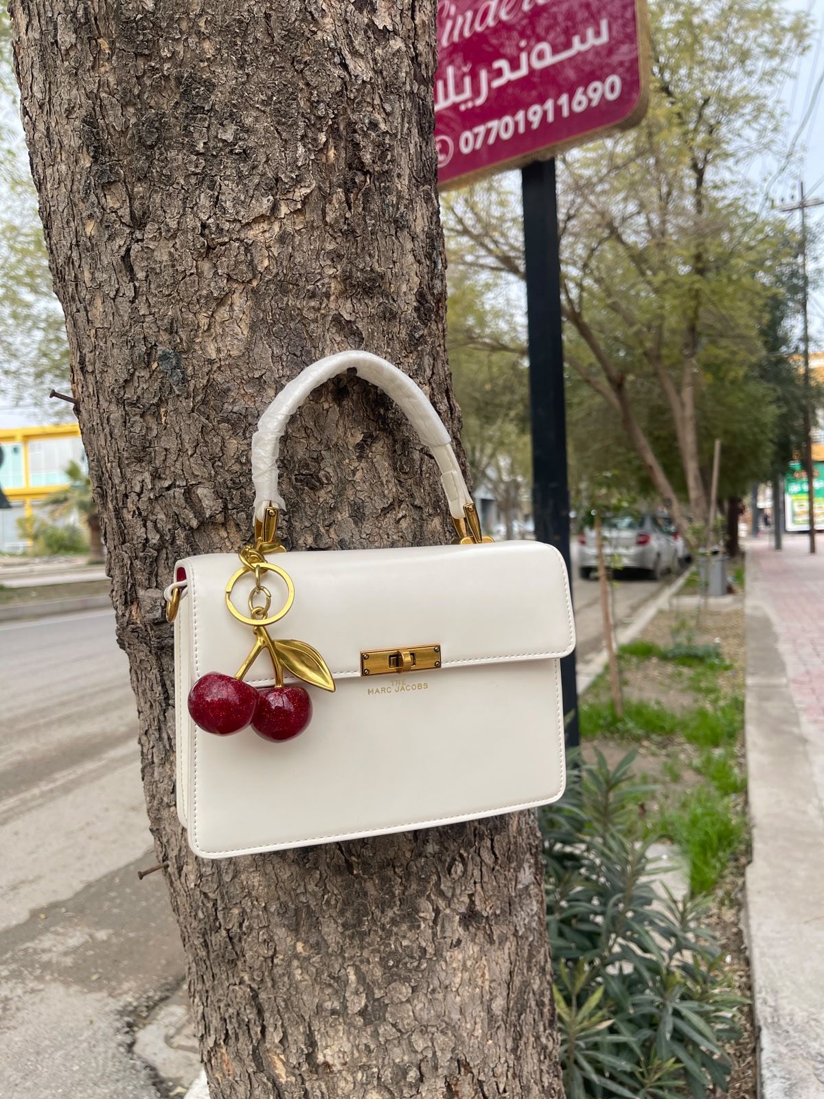 The Marc Jacobs White Top Handle Bag With Cherry Charm